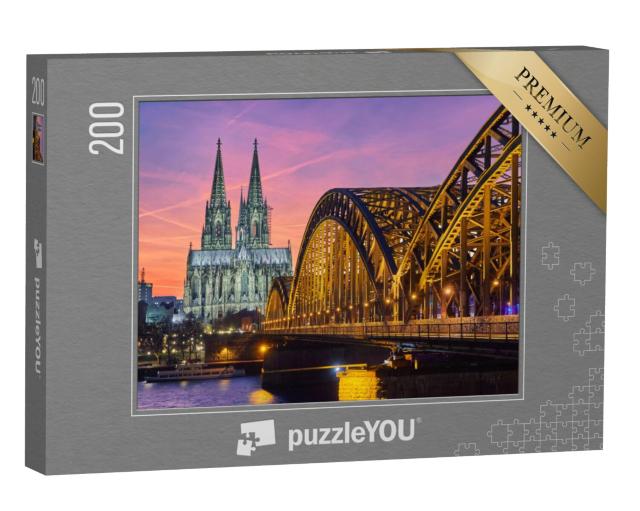 Puzzel 200 stukjes „Dom van Keulen en Hohenzollernbrücke bij zonsondergang“