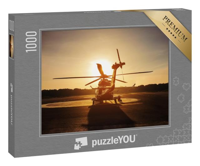 Puzzle 1000 Teile „Hubschrauber auf dem Landeplatz im Sonnenuntergang“