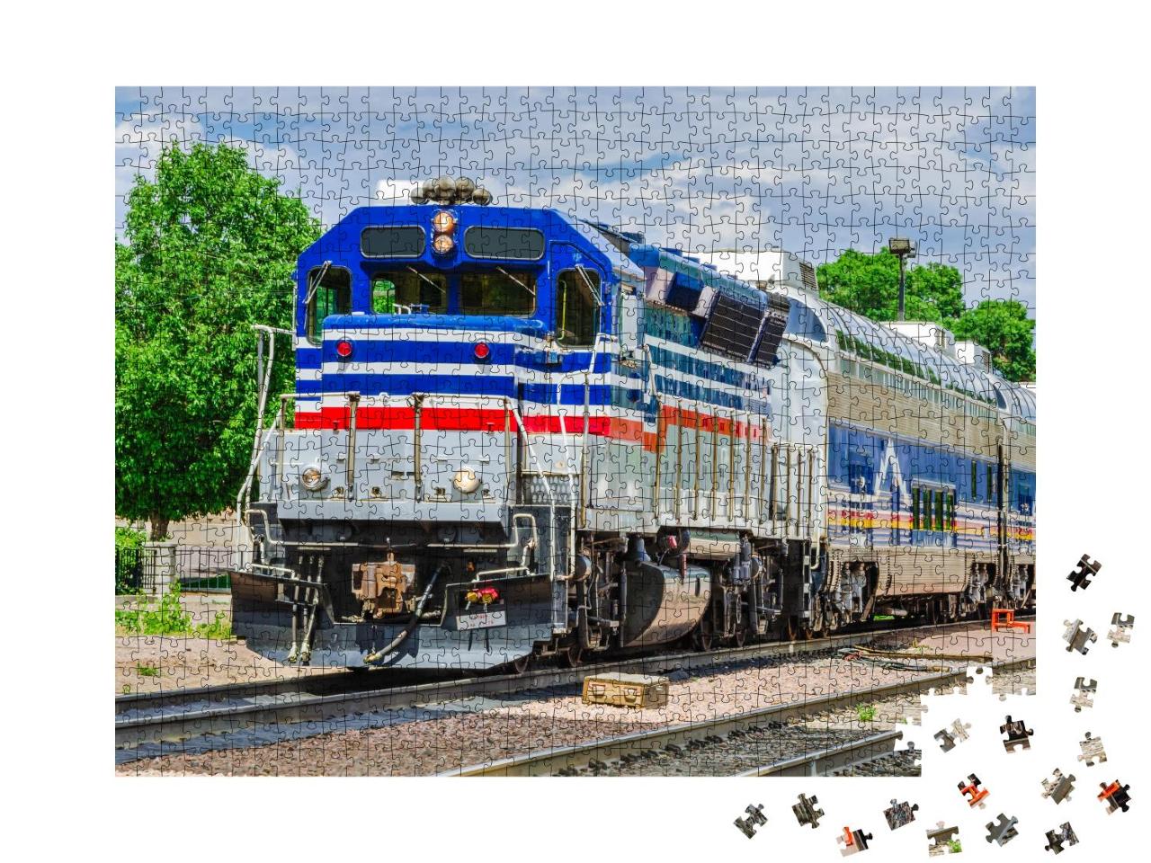 Puzzle 1000 Teile „Eine bunte Diesellokomotive unter bewölktem Himmel“