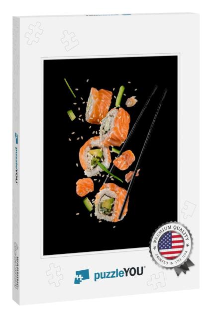 Sushi Pieces Placed Between Chopsticks, Separated on Blac... Jigsaw Puzzle