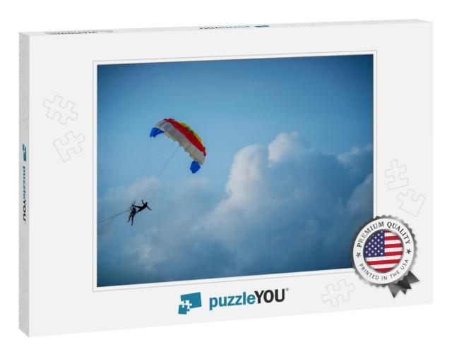 Two Tourists Are Playing the Parasailing in the Sky Durin... Jigsaw Puzzle