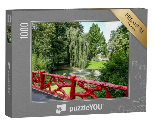 Puzzel 1000 stukjes „Rood houten hek en meer met fontein in het stadspark "Valkenberg" in Breda“