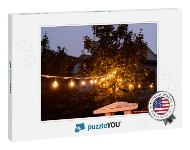 Decorative Outdoor String Lights Hanging on the Tree in t... Jigsaw Puzzle