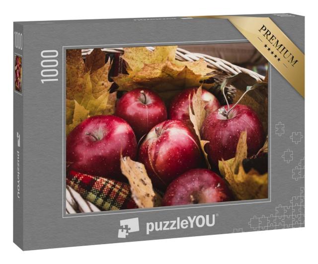 Puzzle 1000 Teile „Ernte von roten Äpfeln in einem Korb voller Herbstlaub“