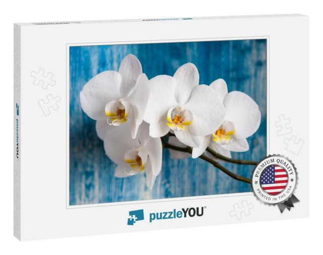 White Orchid Flower on Blue Wooden Background... Jigsaw Puzzle